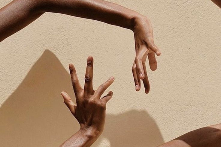 Hands reaching toward each other